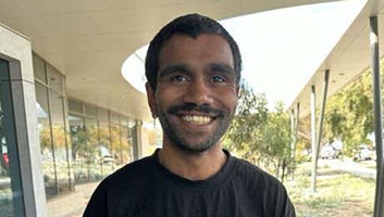 Robert is smiling after passing his driving test.