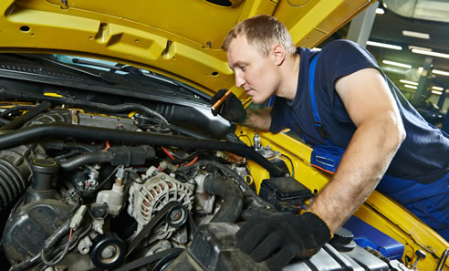 Man inspecting a vehicle