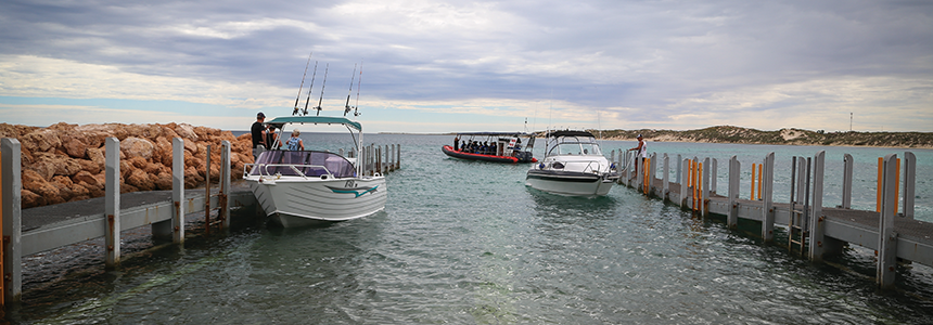 Boats moored at the two finger jetties at Coral Bay Maritime Facility