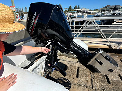 A skipper ensuring the engine is up and off the travelling bracket.