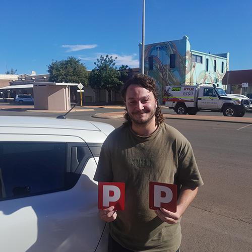 Damon with his P plates after passing his practical driving assessment