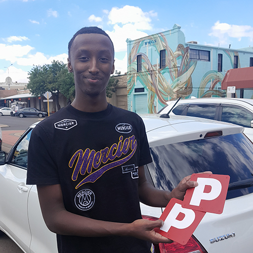 Samiir with his P plates after passing his practical driving assessment