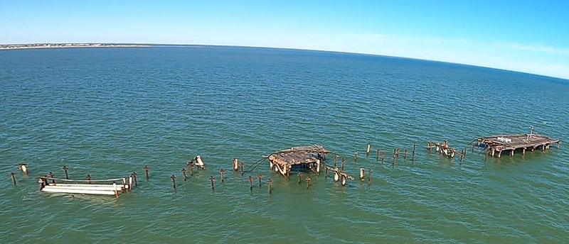 Deconstructed one mile jetty and remaining jetty piles in the water. 